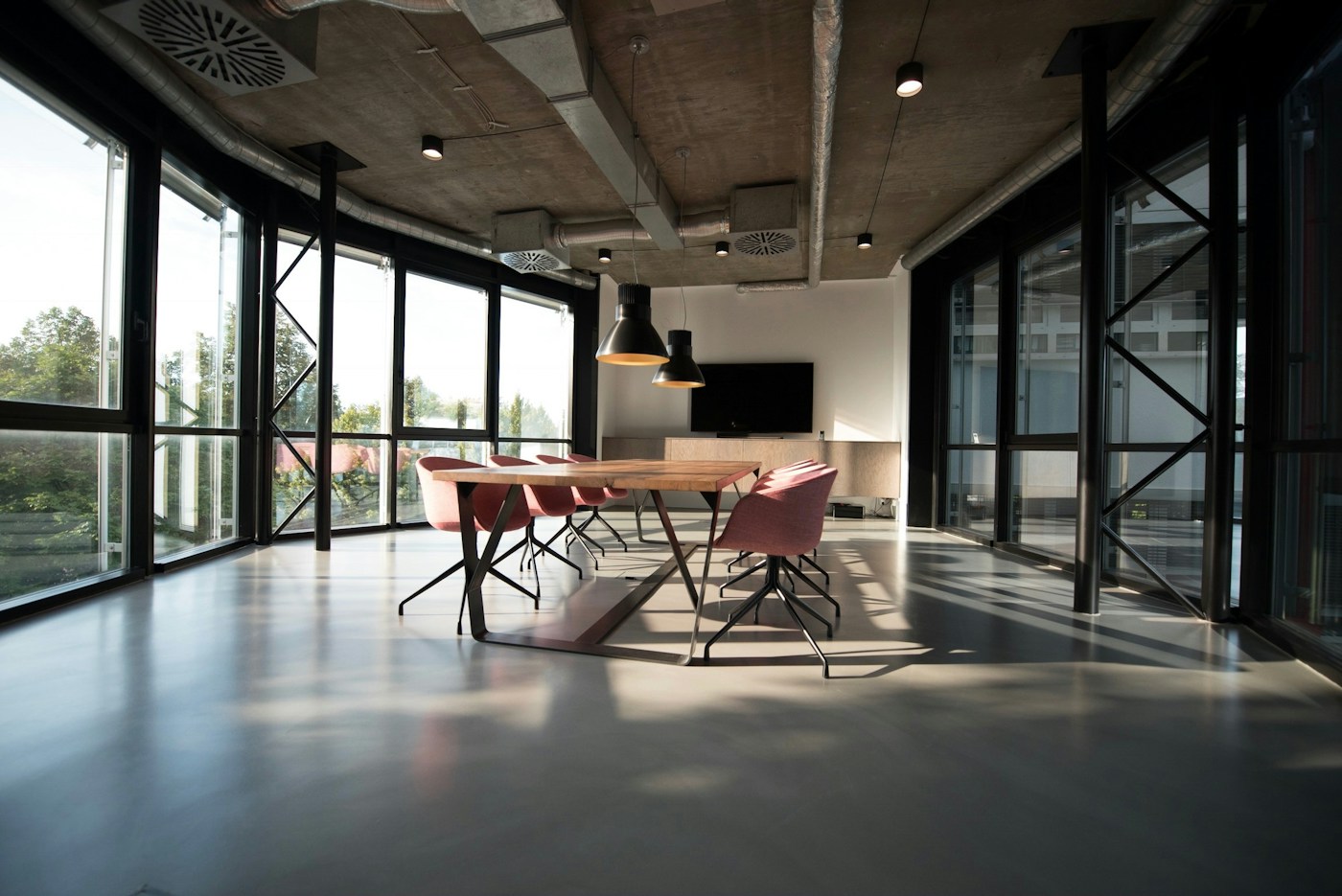 A bright contemporary workspace with desks and greenery
