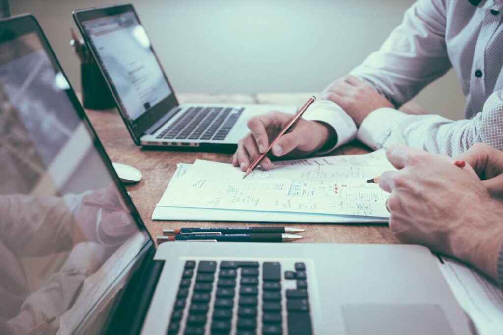 Business planning with documents and a laptop for hiring website developer preparation