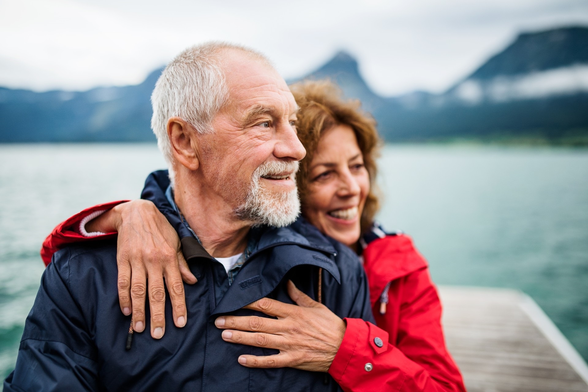 A retired couple enjoying time together by a mountain lake